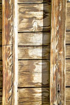 stripped paint in the blue  wood door      and rusty      nail