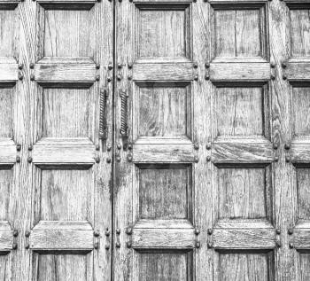 abstract texture of a brown antique wooden old door in italy europe