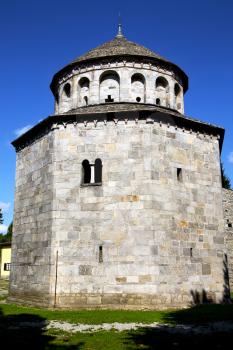  italy  lombardy     in  the arsago seprio   old   church   closed brick tower  wall grass