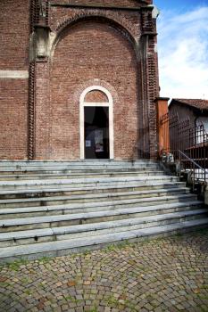 lombardy    in  the  cardano al campo  old   church  closed brick tower sidewalk italy 

