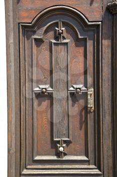 brebbia abstract   rusty brass brown knocker in a  door curch  closed wood italy  lombardy 