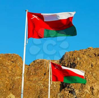 and the cloudy sky in oman waving flag mountain
