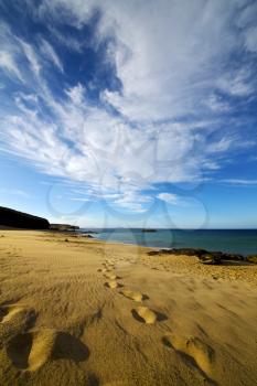 footstep in lanzarote   spain  rock stone sky cloud beach  water  musk pond  coastline and summer 
