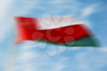 and the cloudy sky in oman waving flag  blurred