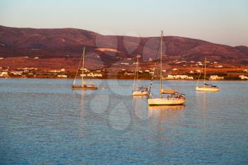 in greece near the coastline boat and yacht and sunrise light