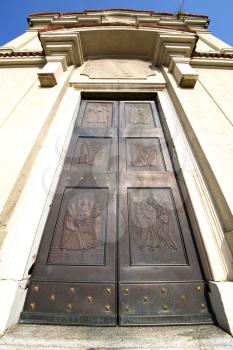 cairate abstract   rusty brass brown knocker in a  door curch  closed wood italy  lombardy 