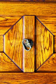 arsago seprio   
lombardy  castellanza blur   abstract   rusty brass brown knocker in a  door curch  closed wood italy   cross
