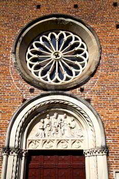  italy  lombardy     in  the castellanza   old   church   closed brick tower   wall rose   window tile   