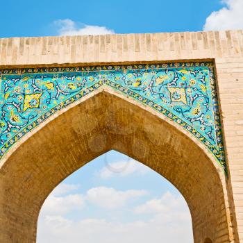 blu in iran  the old bridge and the river antique construction near nature