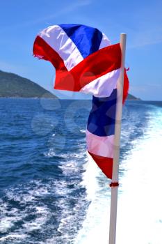 asia  kho samu bay isle waving flag    in thailand and south china sea 