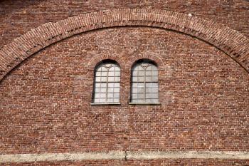  italy  lombardy     in  the  cardano campo    old   church   closed brick tower   wall rose   window tile   
