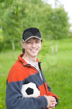 Smilling man with soccer ball outdoors