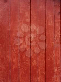 Vertical parallel wooden planks, painted in red