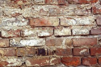 Detail of old brick wall with shelled color paint layers