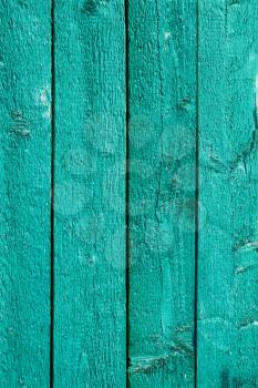 Detail the fence of parallel vertical wooden boards painted in gree