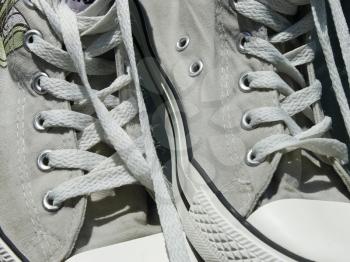 Pair of old women's sports shoe with laces close up