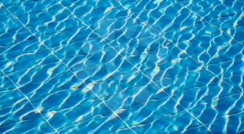 Hotel swimming pool with sunny reflections