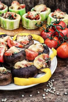 Easy appetizer of mushrooms stuffed with cheese,garlic and tomatoes.Photo tinted.
