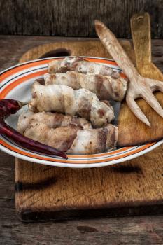 pork sausages on plate on wooden board rustic