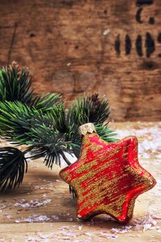 old-fashioned Christmas toy on the background of fir-tree branches