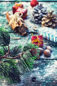 decorations for Christmas on wooden background strewn with pine cones and spices.Selective focus
