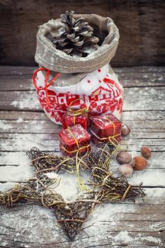 Vintage pouch with cones on the background of Christmas decoration.