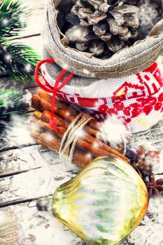 Christmas bag with fir-cone,cinnamon and Christmas decorations.Image is tinted