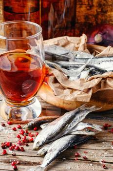 Glass of beer,smoked sprat,spices in traditional  rustic style 