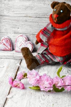 Symbolic soft toy bear and a wooden heart