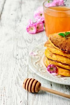 pumpkin pancakes with light dishes and glass of juice