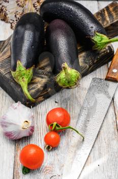 Harvest vegetables aubergine on wooden background in rustic style