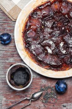 Homemade sweet cake with crop of plums in rustic style