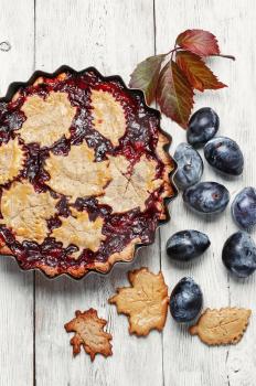 Autumn pie with plum decorated cakes in the form of leaflets