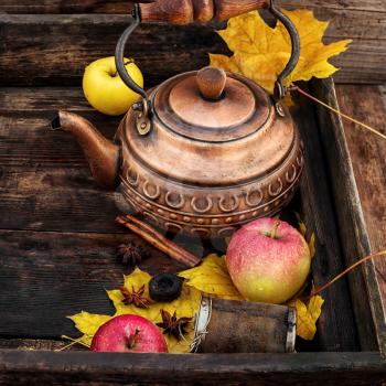 Stylish teapot,apples and maple leaf in rustic style