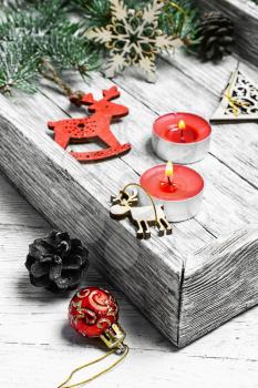 Wooden box with Christmas toys and Christmas tree branch