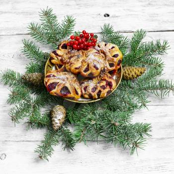 Homemade cookies on plate decorated with fir branches