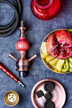 smoking hookah and dish with kiwi,pomegranate and lime