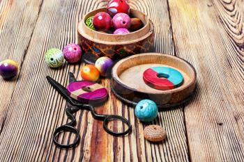 set of stylish beads for making jewelry on wooden background