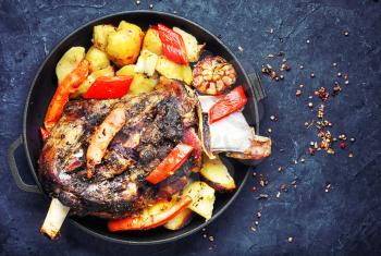 Mutton cooked in a pan with potatoes and vegetables