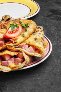 Traditional Russian pancakes stuffed with meat on the plate