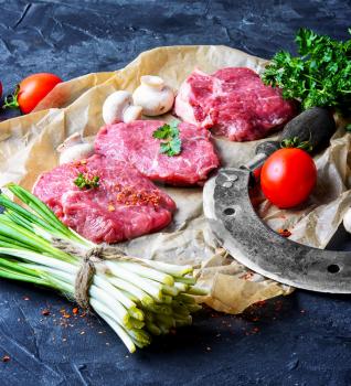 Sliced fresh juicy veal steaks with wild garlic and tomatoes