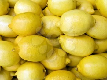 A pile of beautiful lemons on a counter