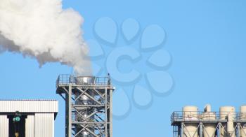 White smoke from the pipe chimney on blue sky background. Industry factory environment ecology pollution