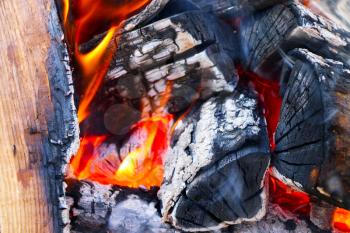 Big firewood burns closeup. Heat barbecue bright ash prepare with small flame