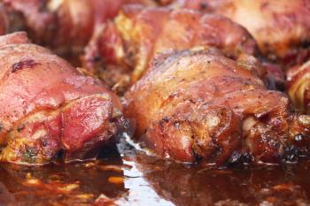 Cooked rosy delicious many pork leg meat barbecue close-up. Hot grill food