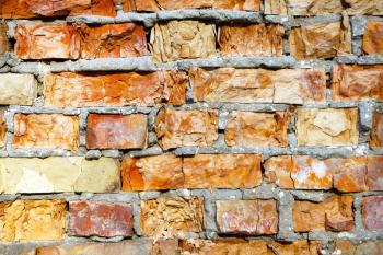 Old destroyed red brick closeup wall background texture. Broken building stone construction