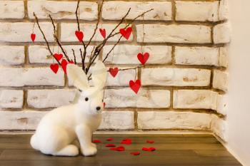 White rabbit and heart tree on brickwall background