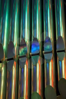 Colorful shining organ tubes in church, vertical photo