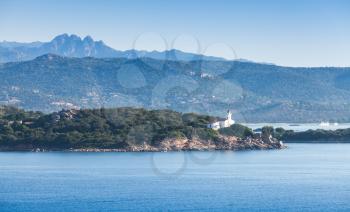 White lighthouse tower, entrance to Porto-Vecchio port, Corsica island, France