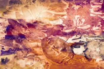 Abstract artistic watercolor background with autumn leaf prints on paper